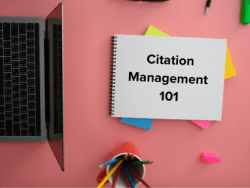 Citation Management 101 written on a piece of paper next to a laptop