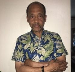 Hassan wearing a tropical print shirt